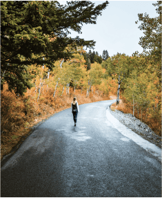 Women walking alone on an empty road