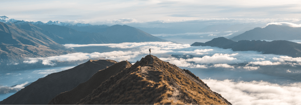 Landscape shot of person standing on a mountain