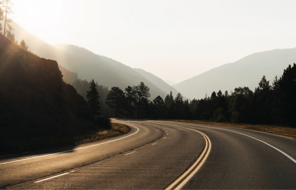 A picturesque highway basking in the warm glow of the sun, beckoning travelers to explore.