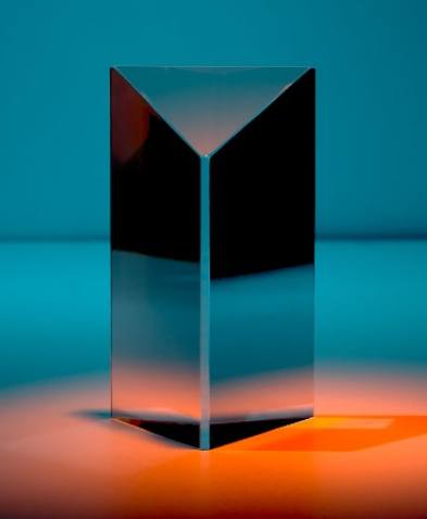 a glass object with a triangular shape