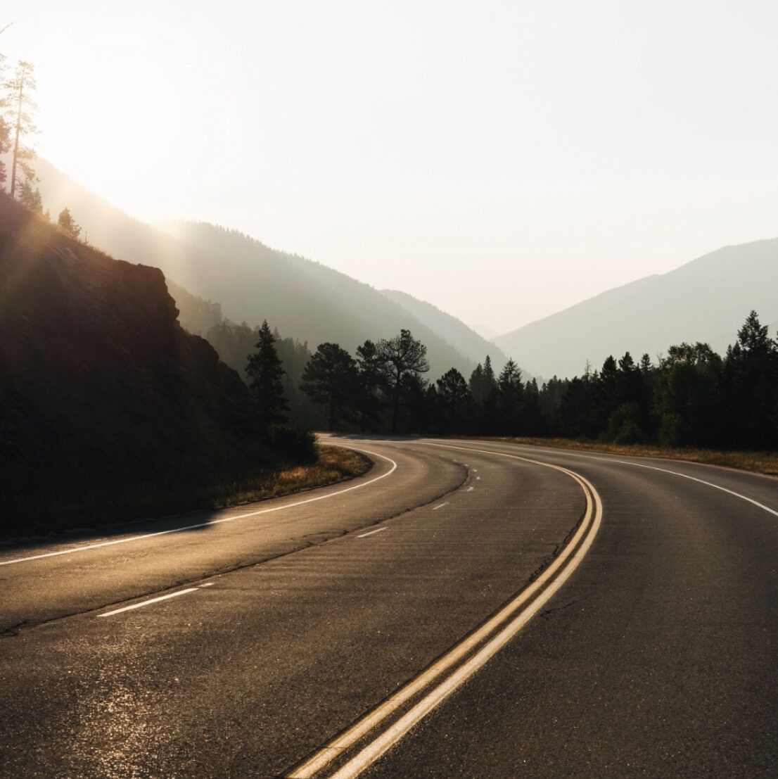 A picturesque highway basking in the warm glow of the sun, beckoning travelers to explore.