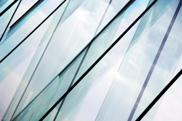 Glass architecture. Double-exposure tilt photo of contemporary office building facade.